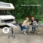 Load image into Gallery viewer, Outdoor RV camping scene with two women using laptops beside a camper van, Starlink Mini Tripod Mount Adapter installed on a tripod for reliable satellite internet